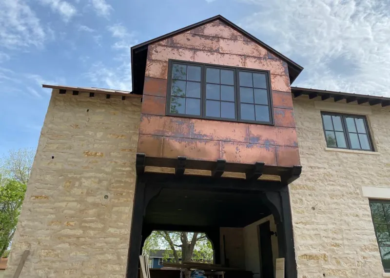 Copper metal panel facade on a stone building for Metal Roof Coating in Dripping Springs